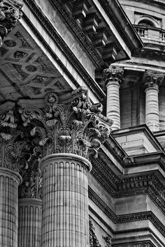 black and white photograph of the top of an ornate building with columns on both sides