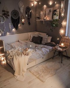 a bed room with a neatly made bed and lots of string lights on the wall