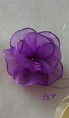 a purple flower sitting on top of a table