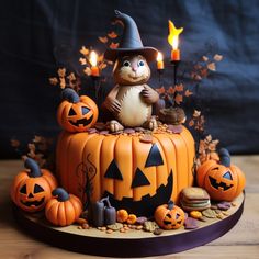 a cake decorated with pumpkins, jack - o'- lanterns and a cat