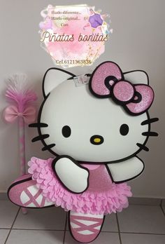 a hello kitty ballerina in pink is standing on a tile floor with a sign that says, princess boutiques