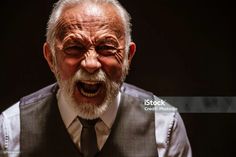 an old man wearing a vest and tie with his mouth open