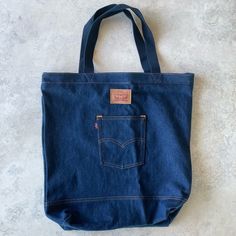 - Levi’s - Tote Bag - Jeans - New With Tags - Internal Pocket - See Pictures For Detailed Measurements Everyday Denim Tote Bag, Everyday Denim Shoulder Bag With Handles, Shopping Bag With Removable Pouch In Denim, Large Bags With Pockets, Large Everyday Bags With Pockets, Shopping Canvas Bucket Bag With Pockets, Blue Bucket Bag With Pockets, Everyday Denim Bags With Handles, Blue Shoulder Bag With Flat Pocket For Daily Use