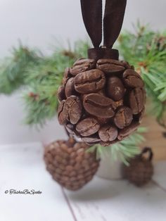 a pine cone ornament hanging from a tree