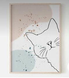 a painting with a cat's face is hanging on the wall