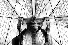 black and white photograph of the brooklyn bridge's face, looking up at it