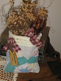 a vase filled with dried flowers on top of a table