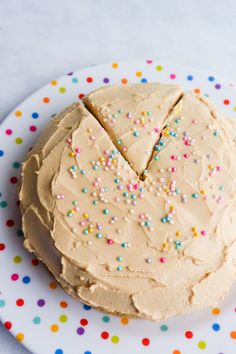 a cake with frosting and sprinkles on a plate