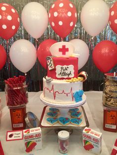 a medical themed cake on a table with balloons