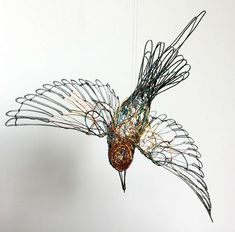 a bird made out of wire hanging from the ceiling