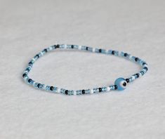 🌀a handmade beaded bracelet with a light blue evil eye charm  🌀made with stretch band to easily slide over your hand  🌀the evil eye helps to ward off curses or malicious intent and protect you from negative energies 🌀17.5 = small  🌀18.5 = small/medium 🌀19.5 = medium 🌀21.5 = medium/large  🌀23 = x-large Cheap Resizable Blue Evil Eye Bracelet, Small Beads Bracelet, Light Blue Evil Eye, Evil Eye Beaded Bracelet, Small Bead Bracelet, Cat Bracelet, Small Beads, Stretch Band, Stretch Bands