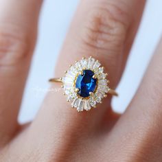 Beautiful Art Deco Sapphire Ring ►Base Metal: Sterling Silver (S925) ►Plating: 14K Yellow Gold Vermeil ►Accented With Simulated Diamonds Main Stone: Sapphire Color: Blue Gemstone Creation: Lab-Created Stone Shape: Oval Cut Gem size: 7.0 x 5.0 mm Carat Weight: 0.76 ct. (Approx.) ►Can be customized. Please contact us if you have special requests. ►Please be aware that plated jewelry can wear off over time, if this is a concern we would suggest going with the sterling silver or solid gold jewelry o Art Deco Sapphire Ring, Sapphire Color, Red Gemstones, Solid Gold Jewelry, Blue Sapphire Rings, Anniversary Gift For Her, Vintage Engagement, Blue Gemstones, Amethyst Ring