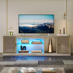 a flat screen tv sitting on top of a entertainment center