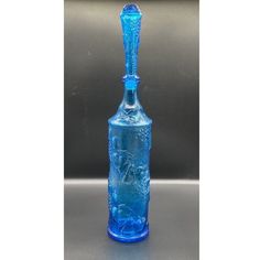 a blue glass bottle sitting on top of a table