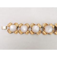 This is part of Chairish’s Costume Jewelry assortment.  Late 1950s goldtone textured flower links with cabochon white moonglow centers with fold over clasp. Marked "Napier" with a copyright symbol. Measures: 7 1/4 inches by 1 3/8 inches.  Condition: Very good; some goldtone wear particularly to the clasp and slight scratches to 1 cabochon that is not easy to see. The matching necklace with blue moonglow is shown on pg. 272 of Melinda L. Lewis & Henry Swen's book "The Napier Co.: Defining 20th Ce Mid-century Gold Jewelry With Cabochon, Mid-century Gold Cabochon Jewelry, Cabochon Bracelet, Copyright Symbol, Flower White, Moon Glow, Modern Branding, Matching Necklaces, Fold Over