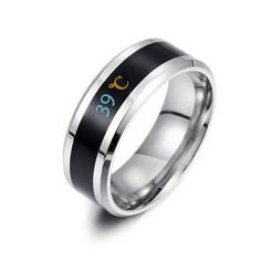 a black and silver ring with an arabic symbol in the center, on a white background