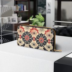 a purse sitting on top of a table next to a book shelf and bookshelf