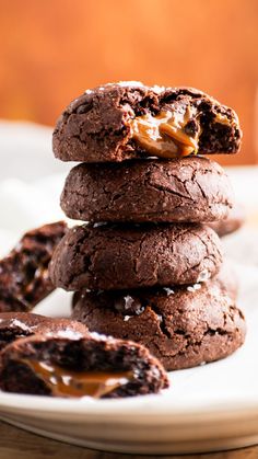 chocolate cookies stacked on top of each other with caramel drizzle in the middle