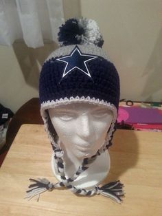 a white mannequin head wearing a hat with a star on it