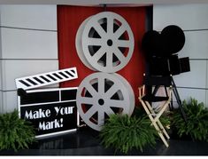 an image of a movie set with film reels and clapsticks on display