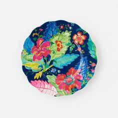 a blue plate with colorful flowers and leaves on it