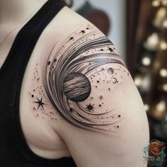 a woman's shoulder with stars and planets in the sky on her left arm