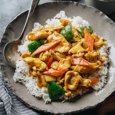 a plate with rice, chicken and vegetables on it