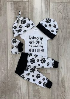 two piece pajamas and hat set with dog paw prints on the front, black and white