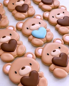 cookies decorated with teddy bears and hearts on a table