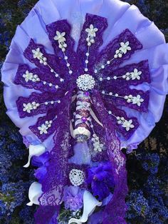 a purple and white fan with jewels on it