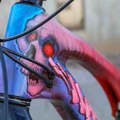 a close up of a painted bicycle with red eyes