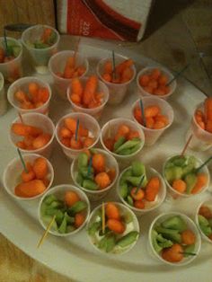 there are many small cups with carrots in them