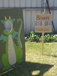 there is a sign that says beware of the dragon and another sign in front of it