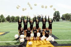 a group of cheerleaders standing on top of a football field