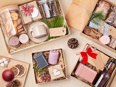 three open boxes filled with different types of food and gifts on a table next to each other