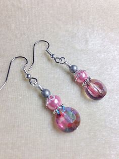 Handmade earrings designed to put a smile on your face every time you put them on. Made using surgical steel ear wires I use wrapped loops to give a finished look. Earrings come with rubber ear backs that slide on to keep earrings from falling out of ears. Color: Antique silver, pink glass pearl, pink glass crystal YOU MAY ALSO LIKE: https://www.etsy.com/shop/JillsHandmadeStuff?search_query=pink+earrings {SHIPPING NOTE} All items are handmade with care after your order is placed. CURRENT ORDER P Jewelry 2022, Pink Crystal Earrings, Beaded Earring, Pearl Pink, Gift For Girlfriend, Pink Earrings, Wire Earrings, Pink Glass, Mom Birthday Gift