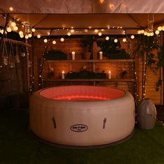 an inflatable hot tub surrounded by string lights