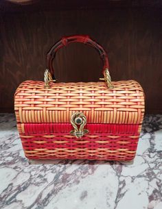 "Vintage Lesco Lona Basket Purse  Top Handle Handbag Woven Basket Weave - Vinyl Structured  Footed New Replacement Handle (Old Handled Had Wear) - Bamboo Style  Gold Tone Lift Latch It appears that perhaps this bag was once totally red and has been faded by the Sun. I like the fade out look of the Red and Natural (Yellowish) Color Red Lining with Gold Accents - 1 Back Pocket Slot Label  Lesco Lona - Made in Hong Kong -  10\"  Wide 5\"  Deep 8\"  Tall 5\"  Drop in Handle Very Nice Condition - No Basket Purse, The Fade, Structured Handbags, Fade Out, Top Handle Bags, Top Handle Handbags, Woven Basket, Basket Weave, Drop In