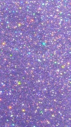 purple glitter fabric with small white and green dots on the top, as well as other colors