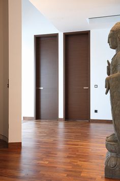 an empty room with wooden floors and doors