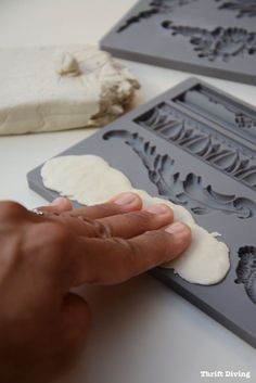 a person is making molds for some type of cake or cupcake decorating