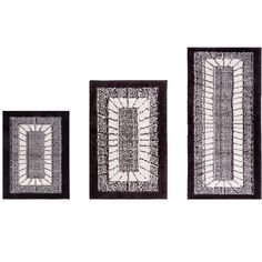 three black and white wall hangings with designs on the sides, one has a square shaped