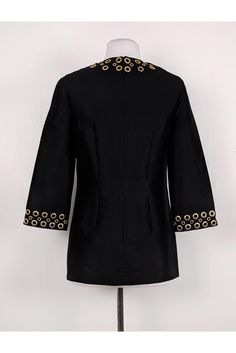 This sophisticated tunic can be worn from day to night. Chic grommets adorn the collar & sleeves. This top is a must-have favorite! Size 2 50% wool, 50% silk Made in Italy Back zipper Rounded neckline 3/4 sleeves Tunic style Gold grommets along neckline & sleeves Bust 34" Waist 33" Shoulder to hem 28" Designer Tops With Embellished Collar For Work, Luxury Evening Tops With Buttons, Michael Kors Spring Work Tops, Michael Kors Spring Workwear Tops, Michael Kors Tops For Spring Workwear, Chic Tops With Embellished Collar For Fall, Formal Spring Top With Embellished Collar, Spring Formal Tops With Embellished Collar, Spring Formal Top With Embellished Collar