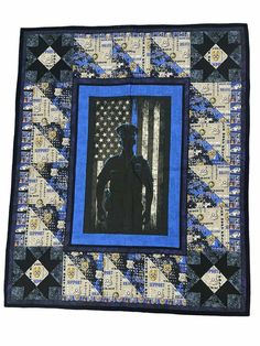 a blue and black quilt with an image of a man standing in front of the american flag