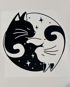 a black and white drawing of two cats in the shape of a moon with stars