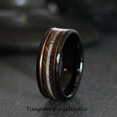 a wedding ring that has been made with wood and white inlays on it