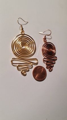 Beautiful 16 gage hammered copper wire wrapped spiral earrings -All pieces are made with top quality tarnish resistant copper wire. Why copper? Copper is a conductor of energy and works wonders when paired with healing crystals. Copper has healing properties itself. For example, not only is it a natural and necessary agent found in the body but it aids in mineral absorption, helps with arthritis, has anti-inflammatory and great anti-aging properties. Most importantly is help with proper immune f Spiral Copper Wire Jewelry With Ear Wire, Copper Spiral Wire Wrapped Earrings, Wire Wrapped Spiral Copper Earrings, Wire Wrapped Copper Spiral Earrings, Gold Spiral Earrings Made Of Copper, Nickel-free Spiral Copper Jewelry, Hand Forged Copper Spiral Earrings, Cooper Jewelry, Loc Jewelry