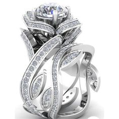 a white gold ring with diamonds on the side and an intricate design in the center