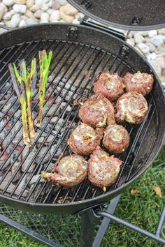 some meatballs are cooking on a grill