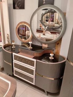 a vanity with an oval mirror above it